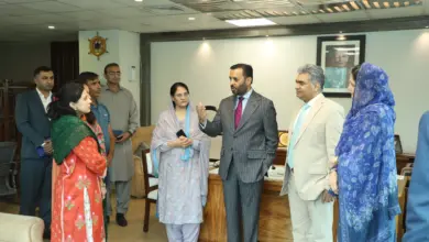 DHO Islamabad officials presenting annual journal book to Federal Health Minister Syed Mustafa Kamal