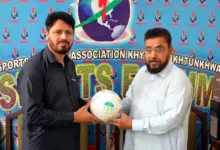 Asim Sheraz receiving a football from Absar Welfare Foundation Chairman Rahat Mian