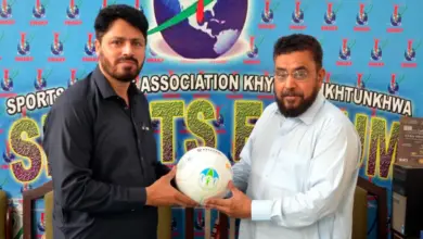 Asim Sheraz receiving a football from Absar Welfare Foundation Chairman Rahat Mian