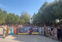 Motorway Police officers and citizens participating in a Kashmir Black Day solidarity walk