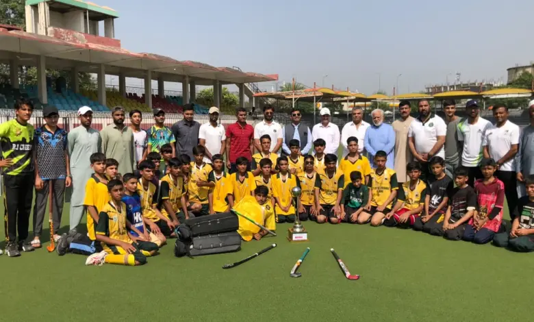 Chamkani players receiving the Peshawar Inter-School Hockey Tournament trophy